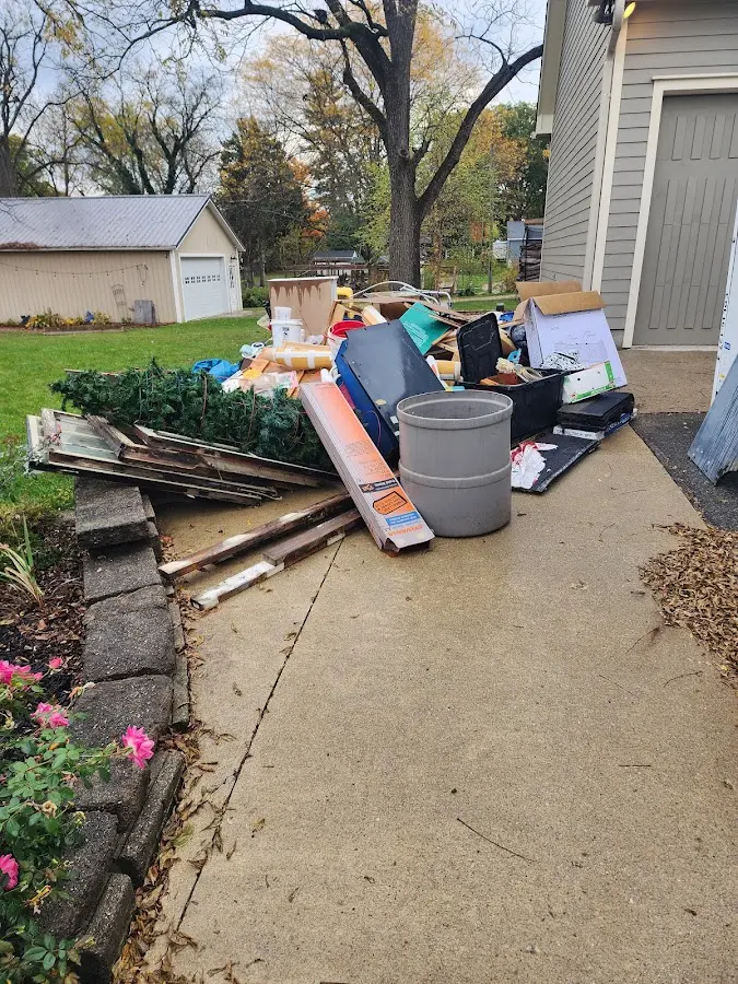 Dumpster being loaded with debris for 3 Yard Dumpster Rental in Tichigan